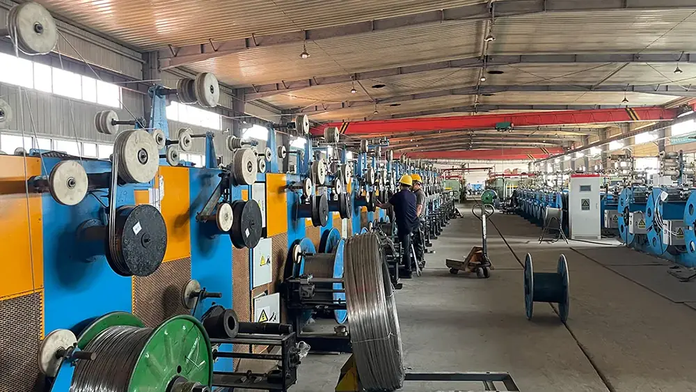 Inside the factory of a wedge wire screen manufacturer showing workers and automated wire drawing production lines